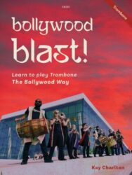 A book cover titled "Bollywood Blast! Learn to play Trombone The Bollywood Way" by Kay Charlton, featuring a group of musicians, including a dhol player and brass band members, in front of a modern building with a vibrant red and orange sky in the background.